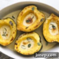 Golden Roasted Acorn Squash with Velvety Sage Cream 7 Close-up of roasted acorn squash with sage cream sauce, perfectly caramelized and ready to be served.