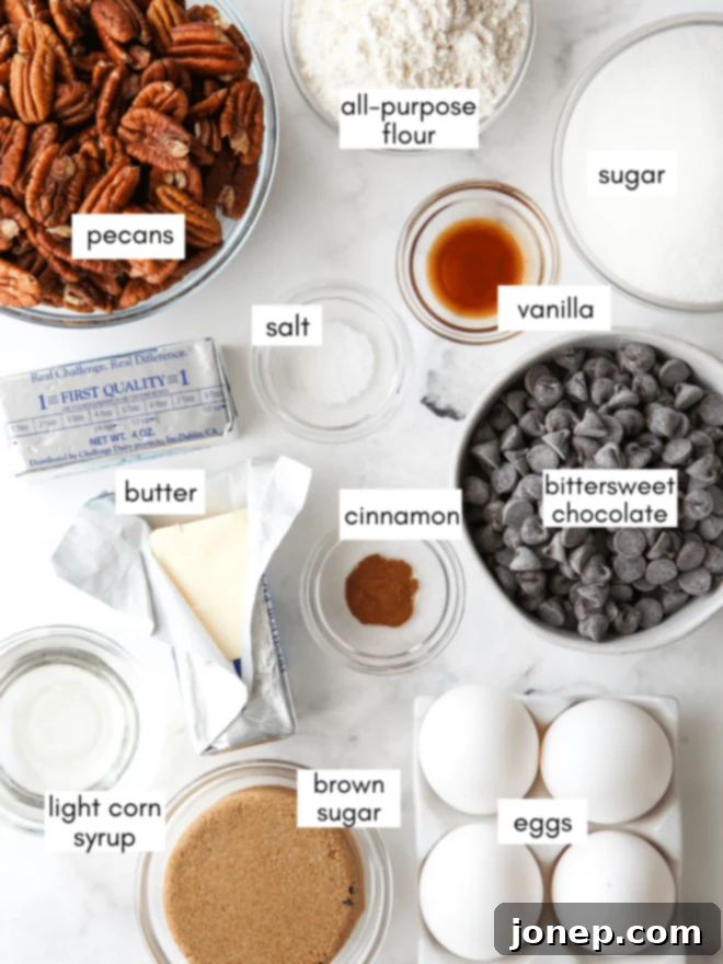 Assortment of baking ingredients including butter, chocolate, sugar, eggs, flour, and a bowl of pecans.