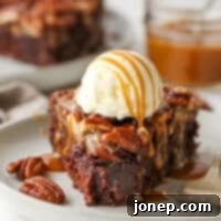 bite taken out of pecan pie brownie covered in ice cream