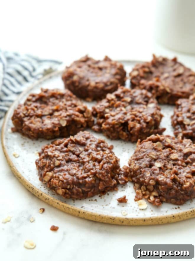 A plate piled high with rustic, delicious-looking no-bake chocolate peanut butter oatmeal cookies, ready to be enjoyed.