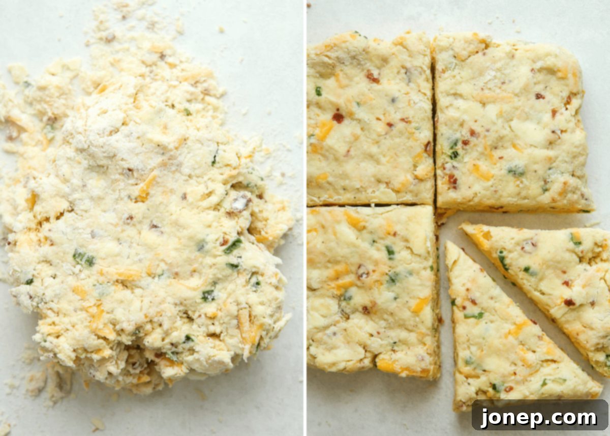 Hands gently folding and flattening scone dough to create layers