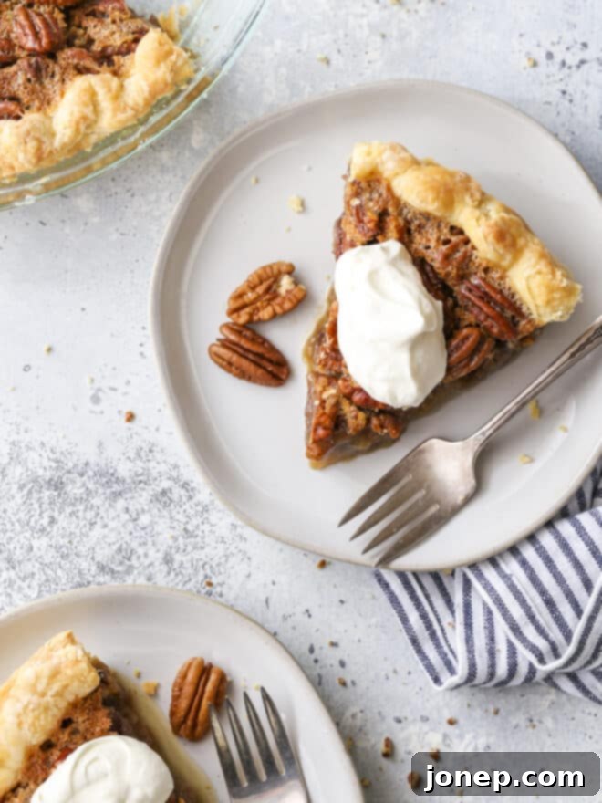Your Ultimate Thanksgiving Pie Companion 2 Pecan pie slices on plates with whipped cream, ready for Thanksgiving dessert.