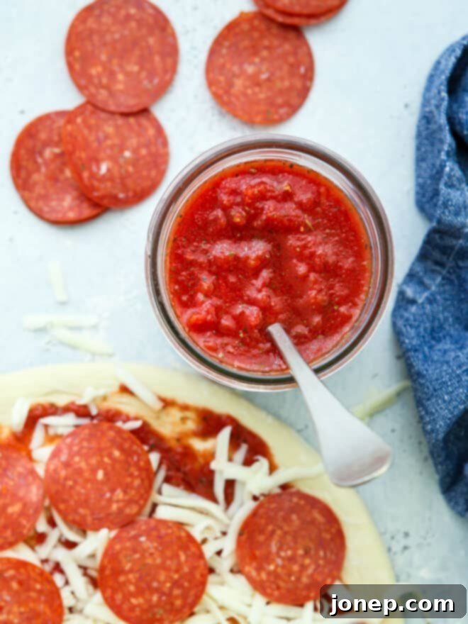 jar of pizza sauce and assembled pepperoni pizza