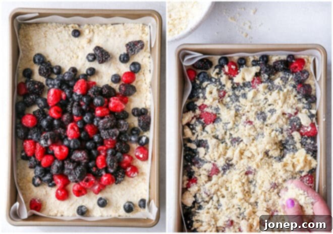 image showing berry filling being spread over crumb crust and topped with remaining crumb mixture