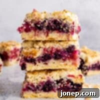 berry crumb bars stacked on top of each other