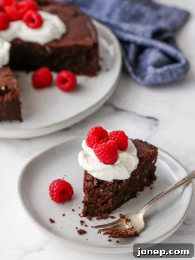 Gluten-Free Chocolate Almond Torte 11 flourless chocolate almond cake with bite taken out it