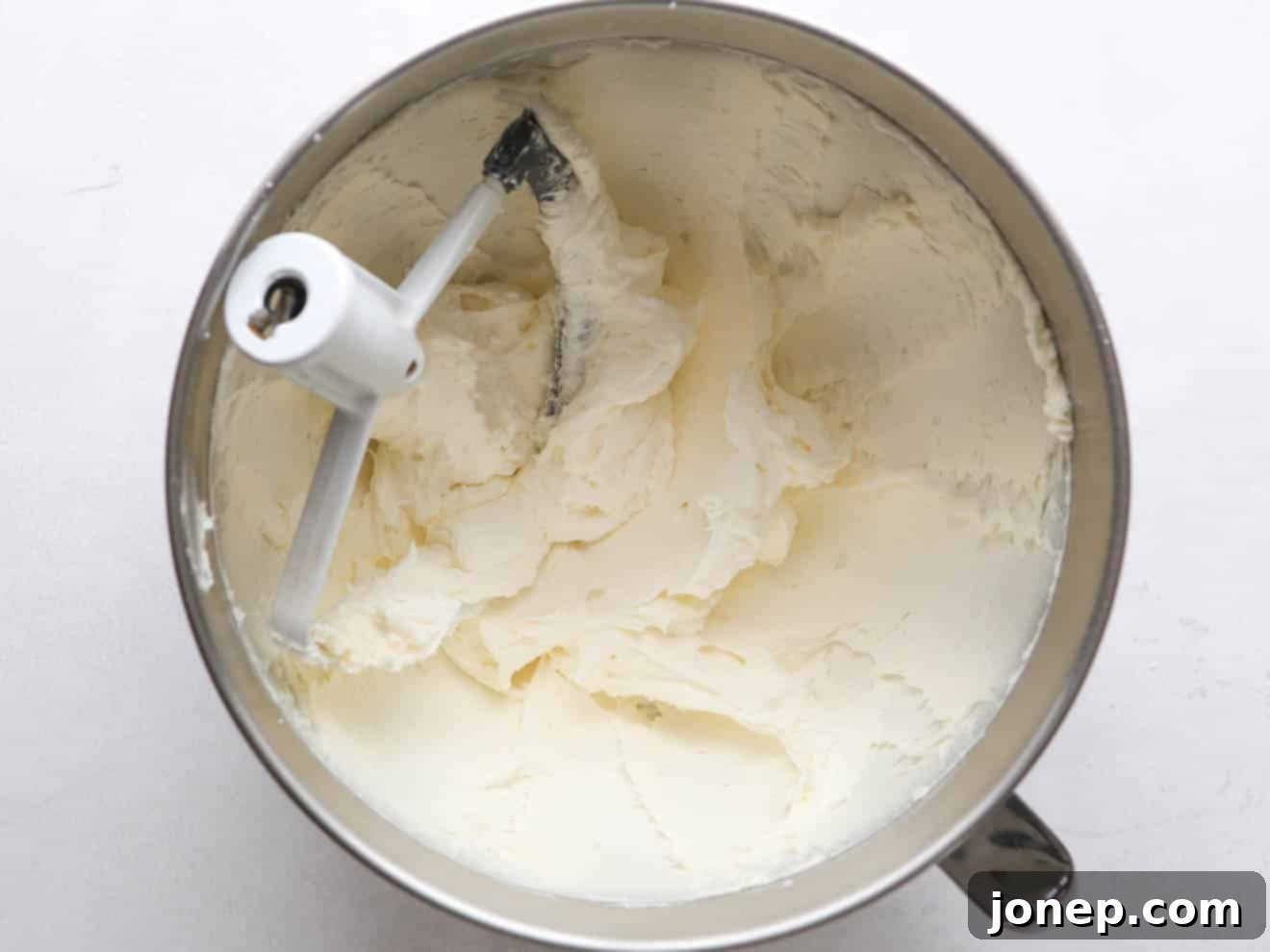 Light and fluffy vanilla buttercream frosting in a mixing bowl.