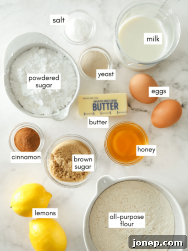 Zesty Lemon Cinnamon Rolls 4 A collection of ingredients for lemon cinnamon rolls, including flour, butter, lemons, sugar, and spices, neatly arranged.