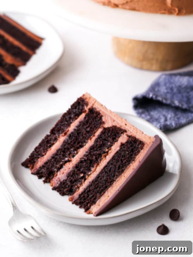 Decadent Chocolate Fudge Layer Cake 3 Close-up of a perfectly sliced chocolate fudge cake, showcasing its moist layers and rich frosting.