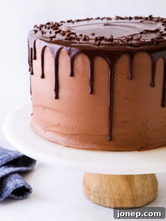 Decadent Chocolate Fudge Layer Cake 8 Close-up of the assembled chocolate fudge layer cake, showcasing the ganache drip and smooth frosting.