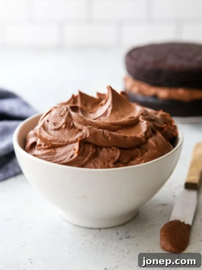Effortless Decadent Fudge Buttercream 2 A bowl of rich, creamy easy fudge buttercream frosting ready to be used as a dessert topping