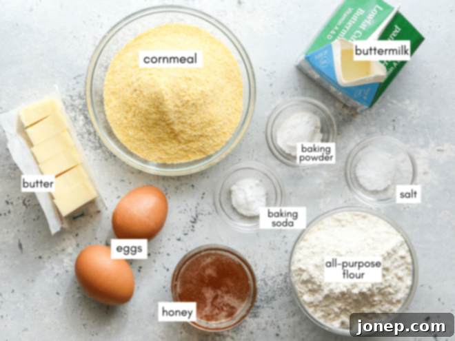 Honey-Kissed Buttermilk Cornbread 3 A flat lay of all the ingredients for honey buttermilk cornbread laid out on a kitchen counter