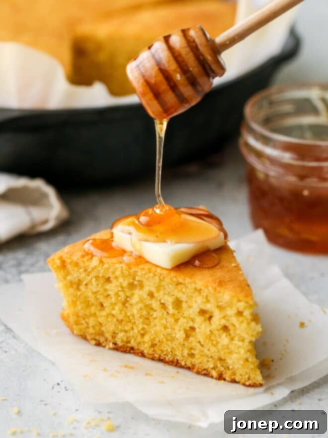 Honey-Kissed Buttermilk Cornbread 7 Hand drizzling honey onto a warm slice of honey buttermilk cornbread