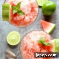 Cooling Watermelon Lime Granita 2 Watermelon Lime Granita served in a small glass bowl with a spoon, highlighting its refreshing texture.