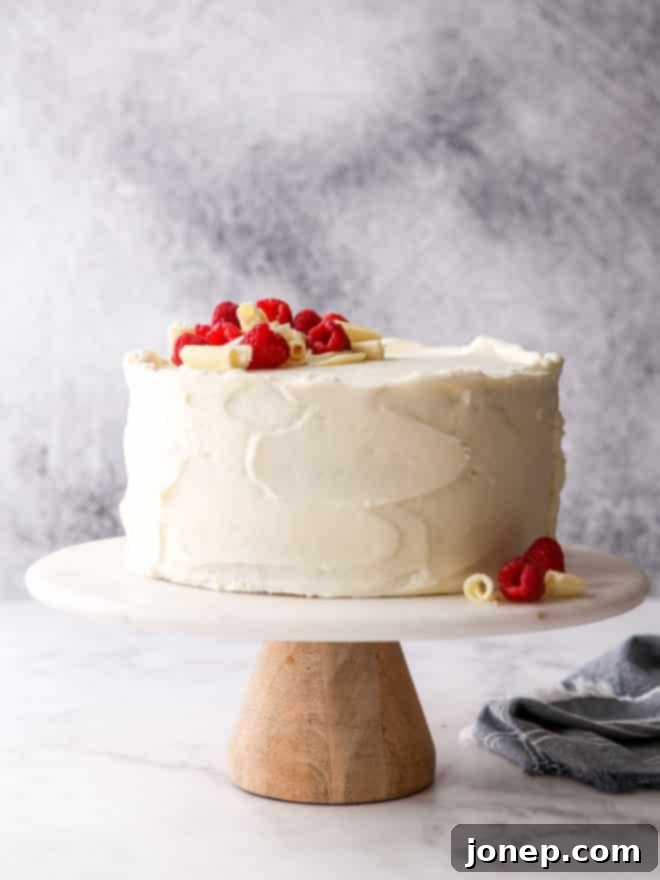 raspberry white chocolate cake on a cake stand