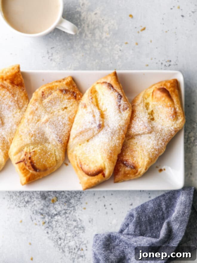 Creamy Danish Delights 2 cream cheese danishes on a plate with a cup of coffee
