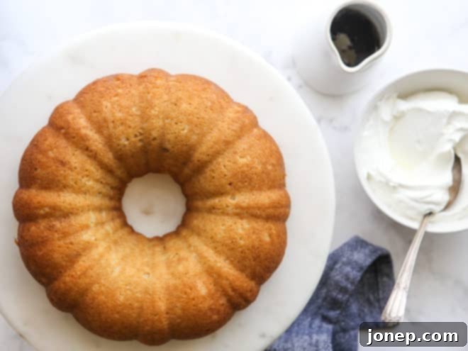 maple bundt cake with bowl of whipped cream and maple syrup