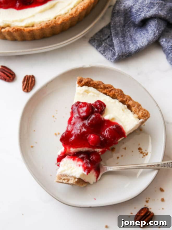 Velvety Cranberry Mascarpone Tart with Golden Pecan Crust 2 slice of cranberry mascarpone tart with bite on fork