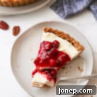 Velvety Cranberry Mascarpone Tart with Golden Pecan Crust 11 slice of cranberry mascarpone tart with bite on fork