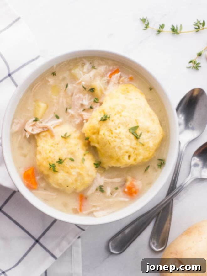 Grandma's Turkey Dumpling Soup 2 A steaming bowl of turkey and dumplings soup, showcasing tender turkey, vibrant vegetables, and fluffy buttermilk dumplings on top. Perfect for using leftover turkey.