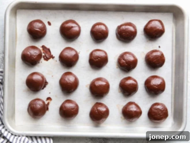 formed truffle centers on a sheet pan, ready for dipping into chocolate coating