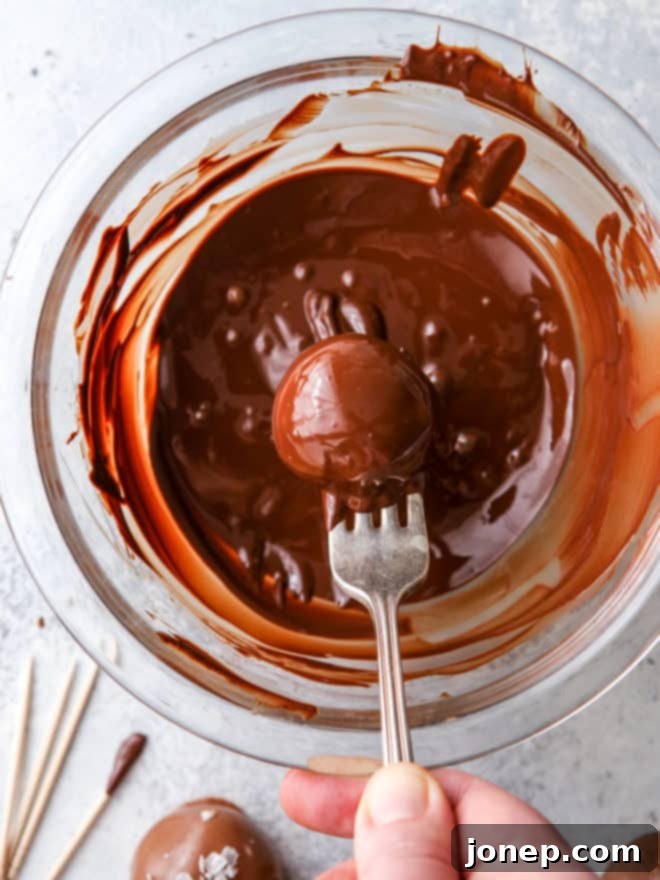 dipping truffles in melted chocolate using a fork