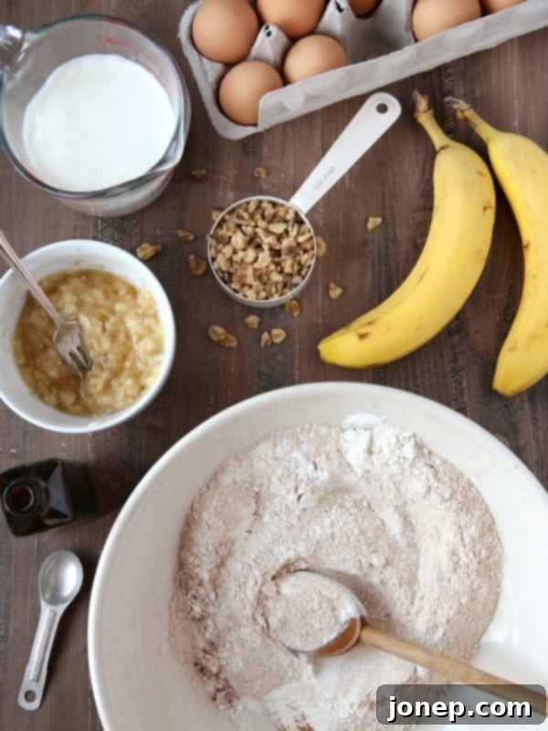 A close-up of fluffy Whole Wheat Banana Nut Pancakes with sliced bananas and walnuts