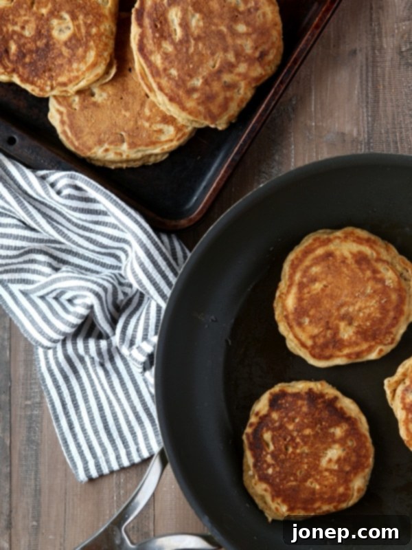 Freshly made Whole Wheat Banana Nut Pancakes drizzled with maple syrup