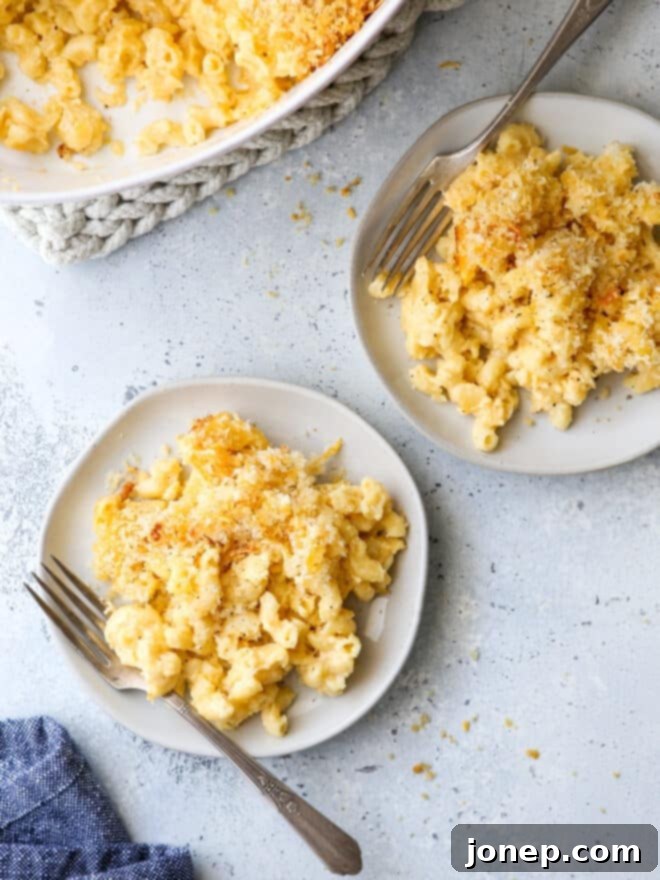 Delicious baked macaroni and cheese served on plates with forks, ready to eat