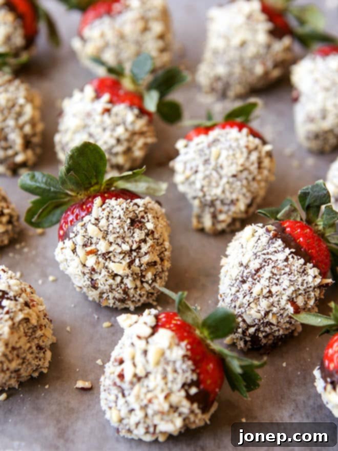 Freshly made chocolate hazelnut covered strawberries on a platter, showcasing their rich chocolate coating and crunchy hazelnut topping.