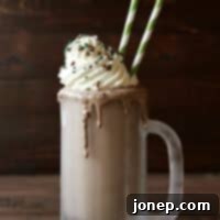 Boozy Creme de Menthe Milkshake with whipped cream and chocolate shavings | completelydelicious.com