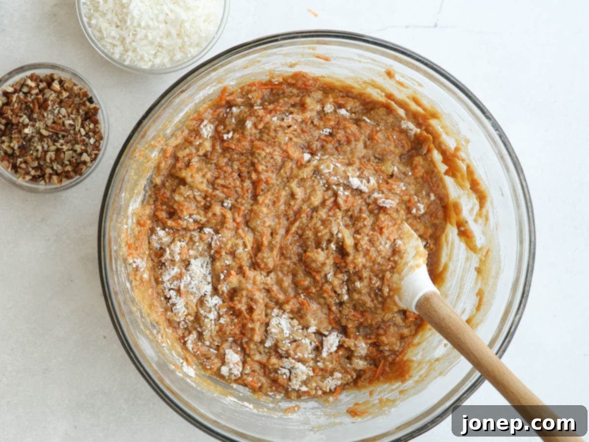 mixing carrot cake batter in a bowl