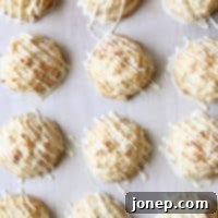 Exotic White Chocolate Macaroon Delights 2 White Chocolate-Dipped Tropical Macaroons with Pineapple, Macadamia Nuts and Coconut | completelydelicious.com