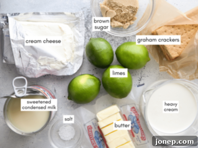 Tangy No-Bake Lime Cheesecake Squares 3 All the fresh ingredients for making no-bake lime cheesecake bars laid out on a table, including limes, cream cheese, and graham crackers.