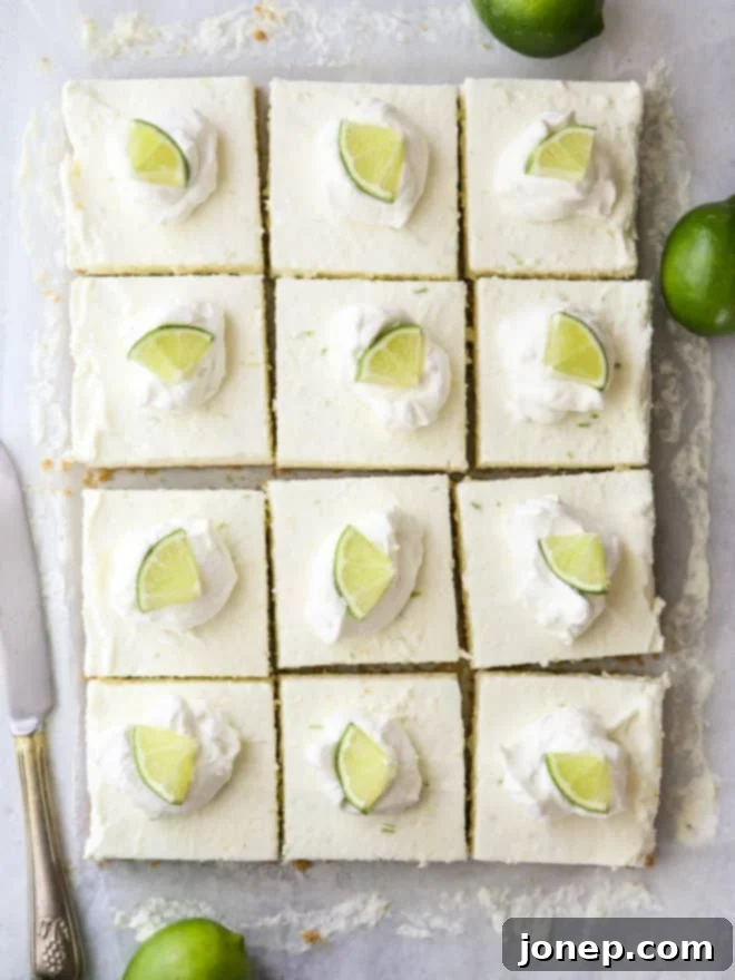 Key Lime No-Bake Cheesecake Bars 7 Beautifully sliced no-bake lime cheesecake bars arranged on a plate.