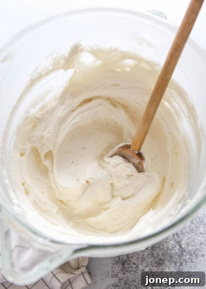 Vanilla Bean Dream Frosting 4 Close-up of the fluffiest whipped vanilla frosting, showcasing its light and airy texture.