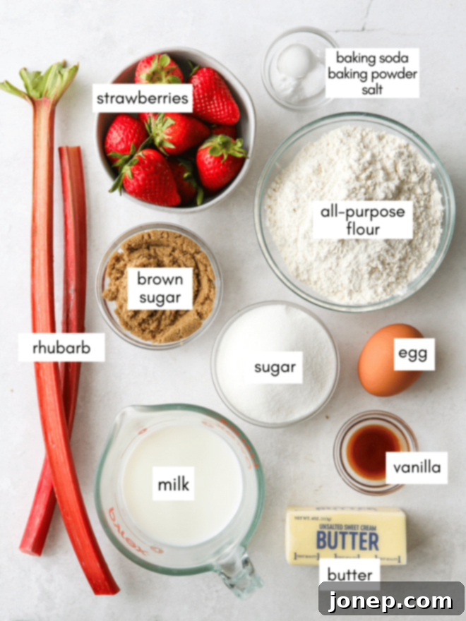 Strawberry Rhubarb Flip Cake 4 Various fresh ingredients laid out on a table, including strawberries, rhubarb, butter, and baking essentials, for making the cake.
