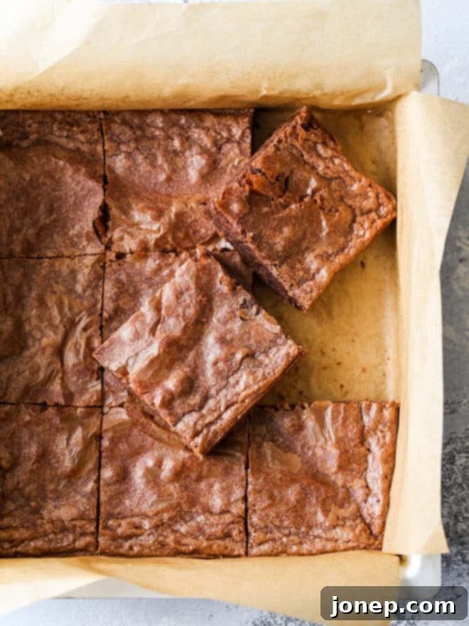 Parchment Paper: Your Baking Secret Weapon 2 cutting classic fudge brownies in baking pan, showcasing how parchment paper helps lift them out