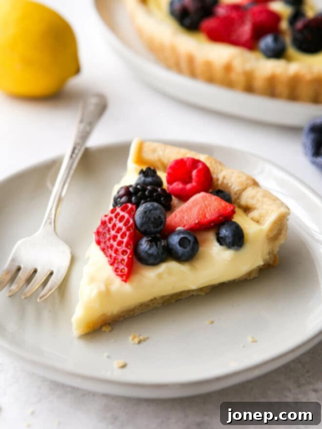 A stunning top-down view of the assembled Lemon Berry Tart, with its colorful array of fresh berries perfectly arranged on the creamy lemon filling, ready to be served.