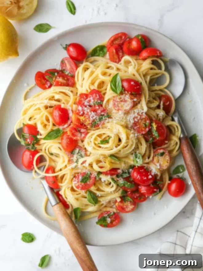 Bright Lemon Tomato Basil Pasta 2 lemon pasta with tomatoes and basil on a plate in utensils