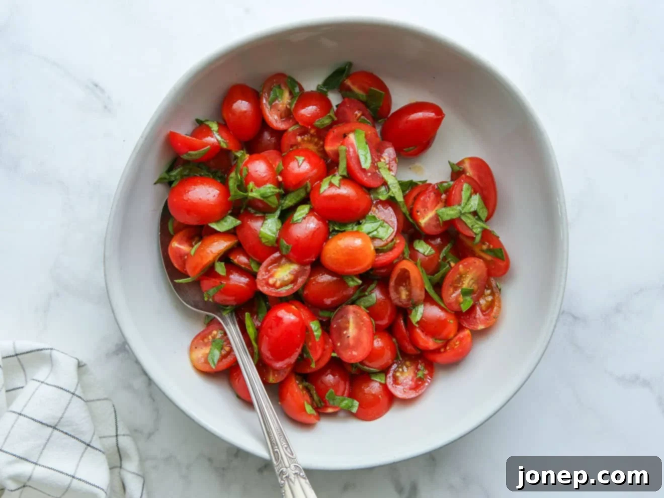 halved tomatoes and sliced basil marinating