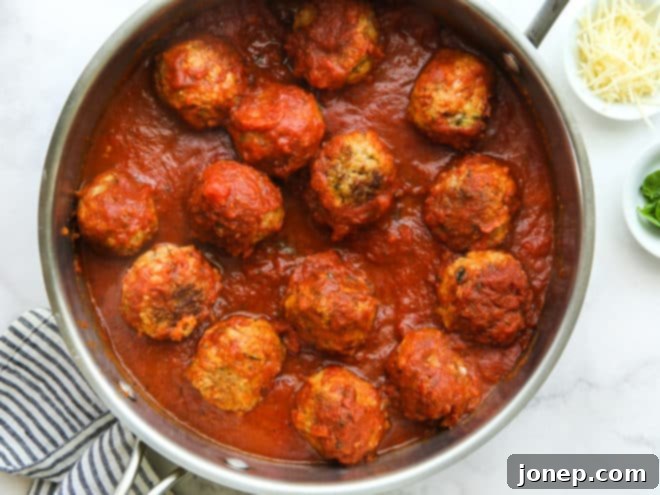 Garden Fresh Turkey Zucchini Meatballs 6 Turkey zucchini meatballs simmering in marinara sauce in a skillet