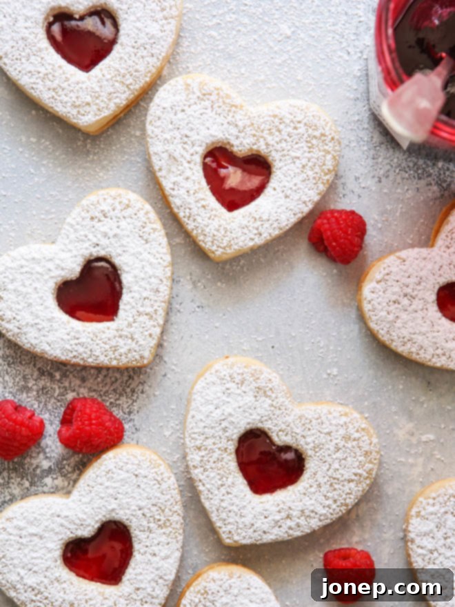 Classic Raspberry Almond Linzer Cookies 2 Raspberry Almond Linzer Cookies with heart-shaped cutouts