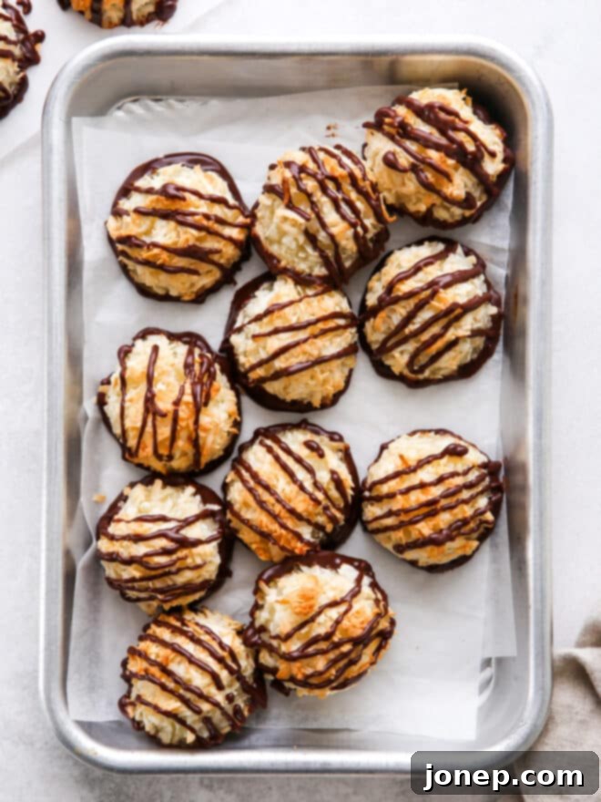 Classic Raspberry Almond Linzer Cookies 11 Golden coconut macaroons drizzled with dark chocolate on a sheet pan