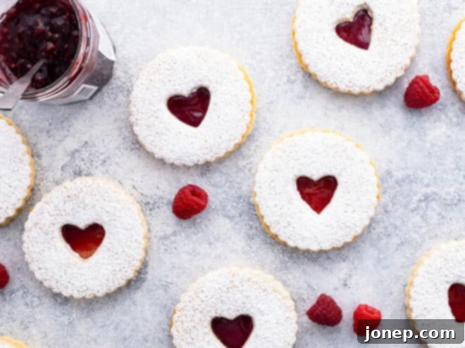 Classic Raspberry Almond Linzer Cookies 8 Close-up of heart-shaped Linzer cookies on a cooling rack