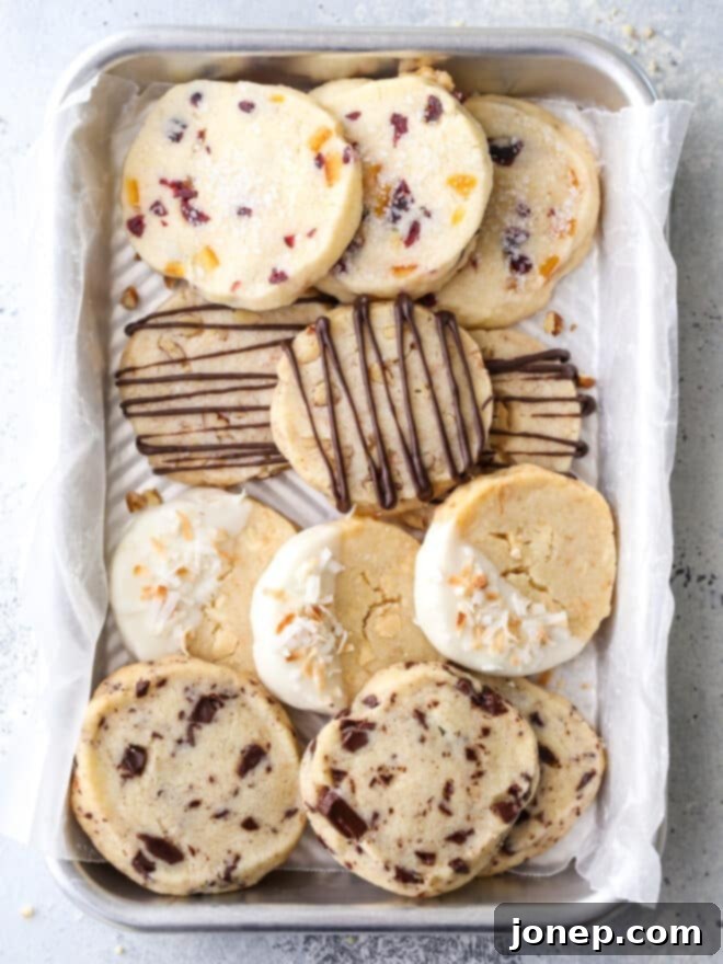 Classic Raspberry Almond Linzer Cookies 9 Four variations of shortbread cookies arranged on a baking tray