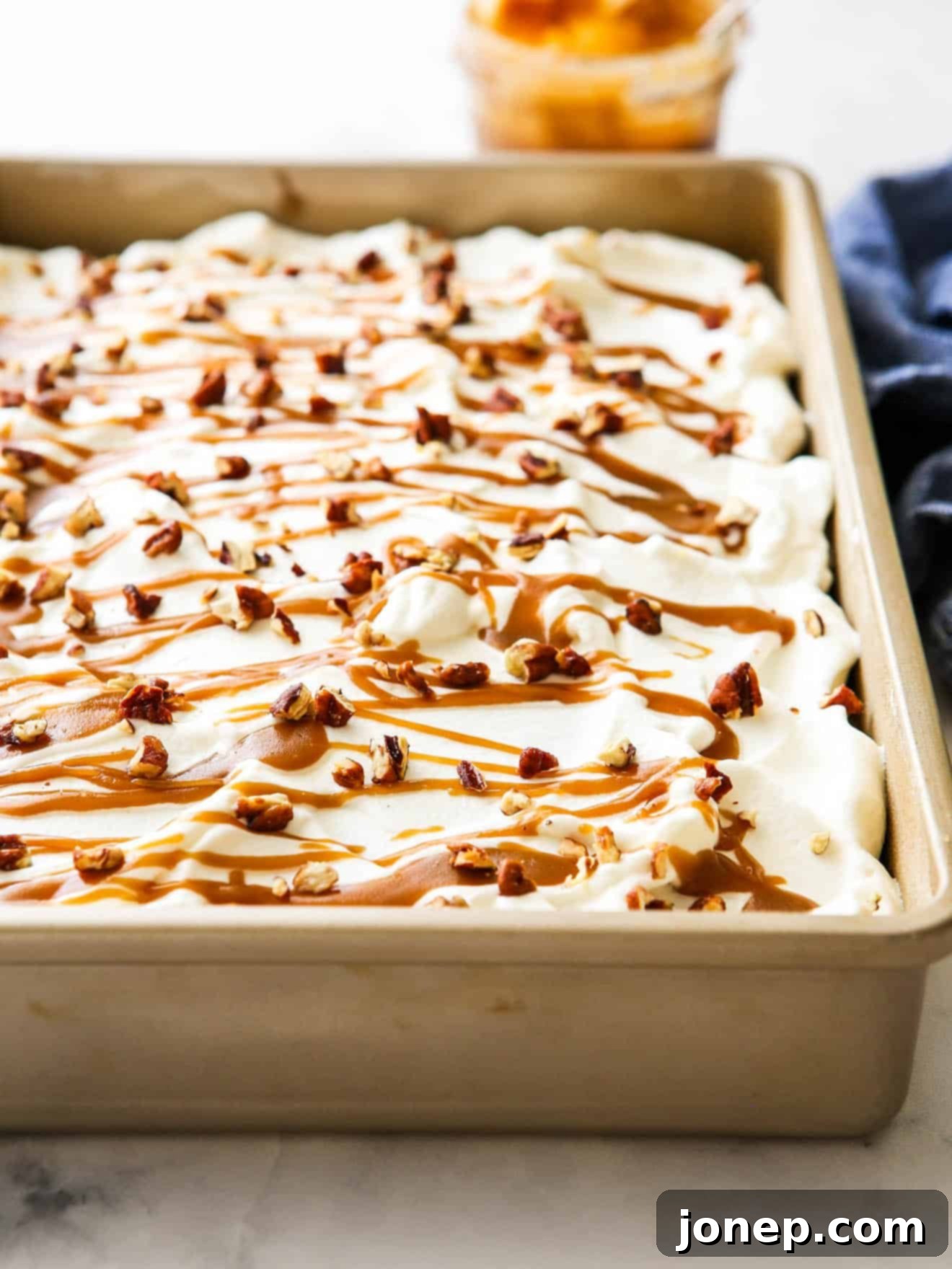 frosted pumpkin caramel poke cake in pan