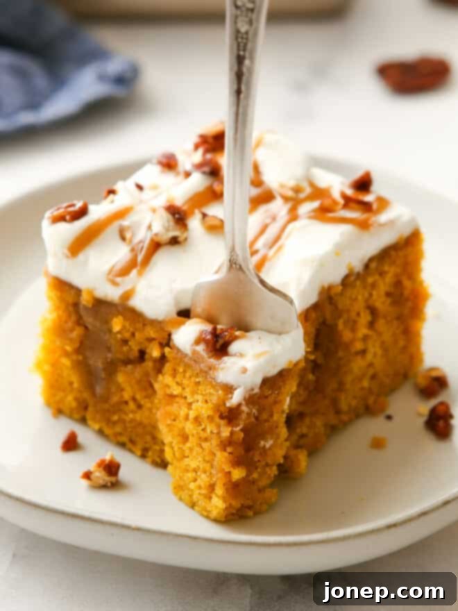 Decadent Pumpkin Caramel Infusion Cake 10 closeup of taking a bite out of pumpkin caramel poke cake