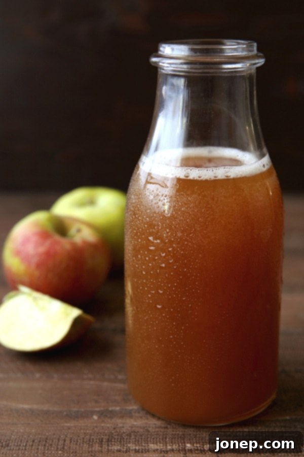 Closeup of homemade apple cider caramel sauce bubbling gently in a saucepan.