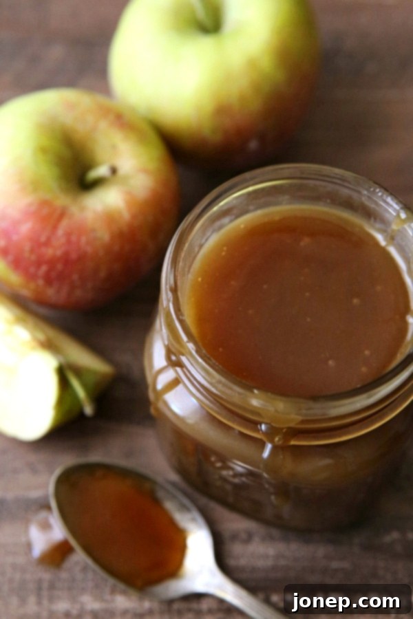 Ingredients for apple cider caramel sauce laid out on a wooden surface.